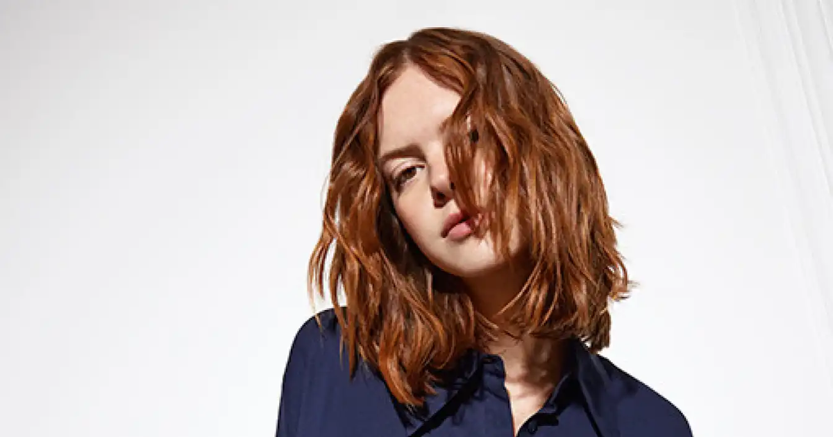 Model with a soft copper long square showing a French haircut technique with natural movement